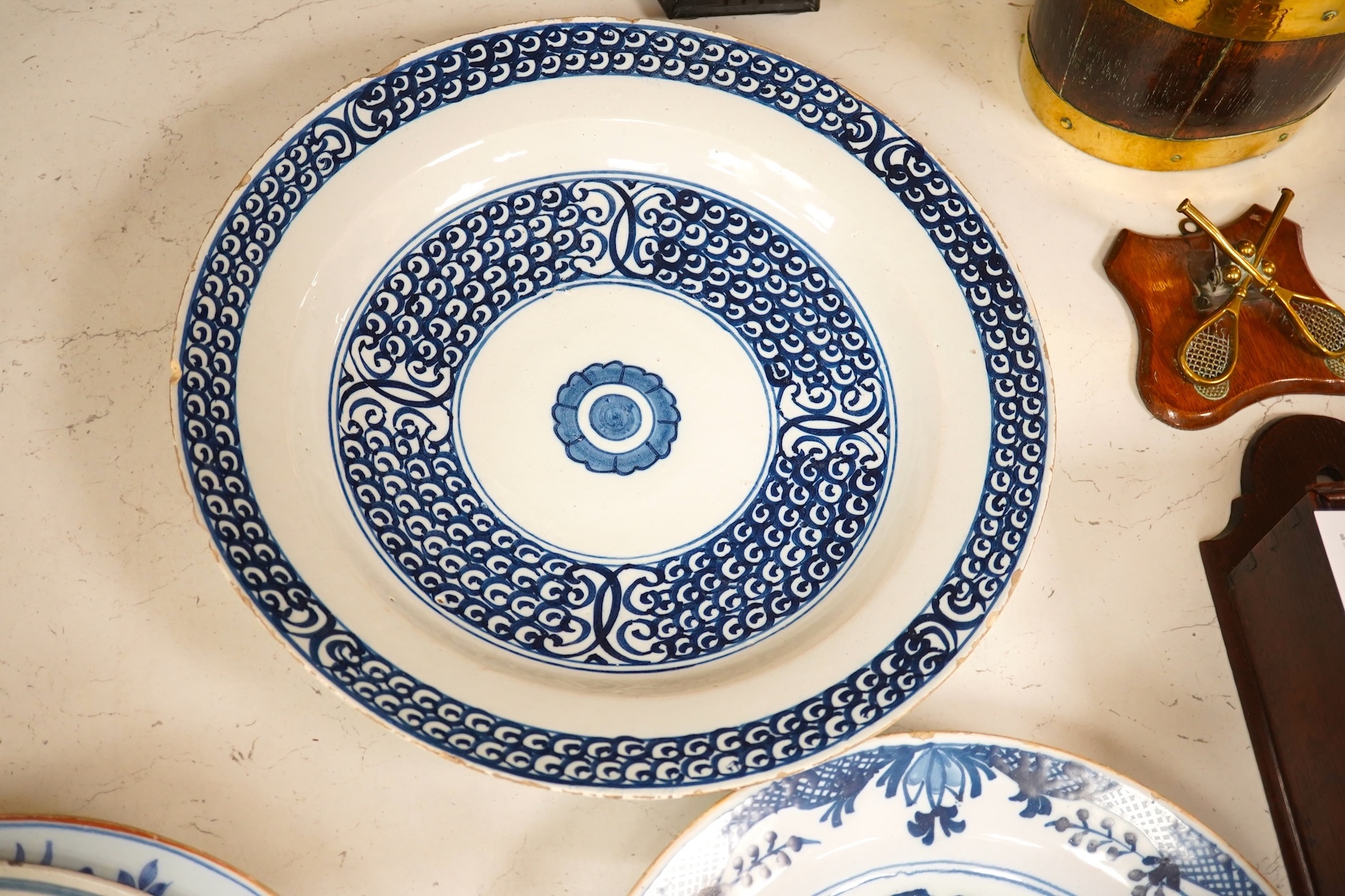 Three 18th century Delft pottery dishes, largest 31cm diameter. Condition - poor to fair